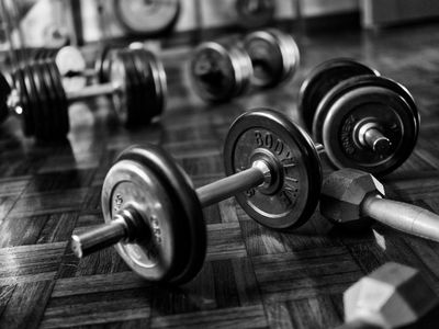 Close up of professional dumbbells on a dark floor