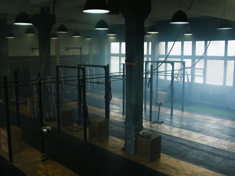 Spacious gym area with modern strength equipment and blue light