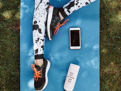 Stopwatch and water bottle on a fitness mat